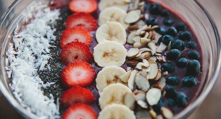 Vibrant acai rainbow bowl with fresh fruits and granola