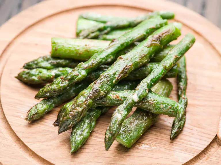 Asaparagus tips with True Lemon Butter on a plate.