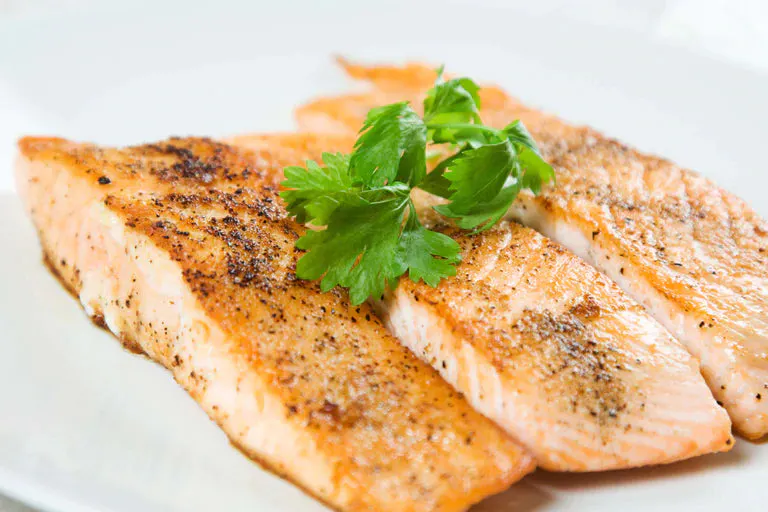 Broiled True Lemon Pepper Salmon on a white plate