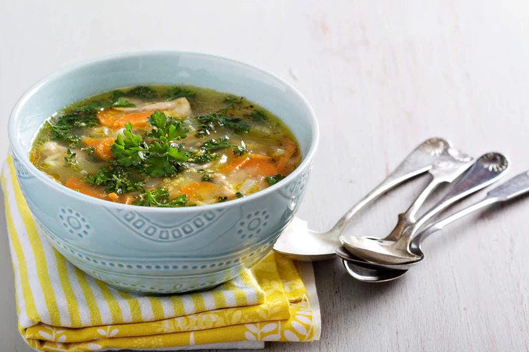 Delicious True Lemon Chicken Orzo Soup in a bowl garnished with parsley