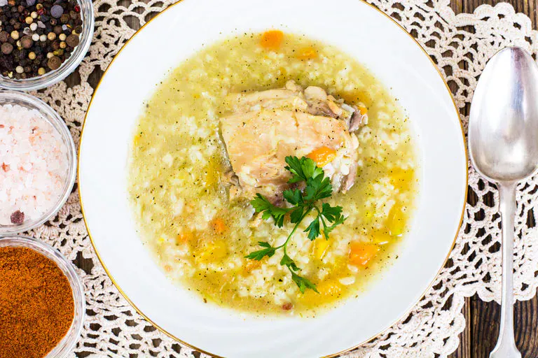 Bowl of soup with chicken, orzo, and carrots