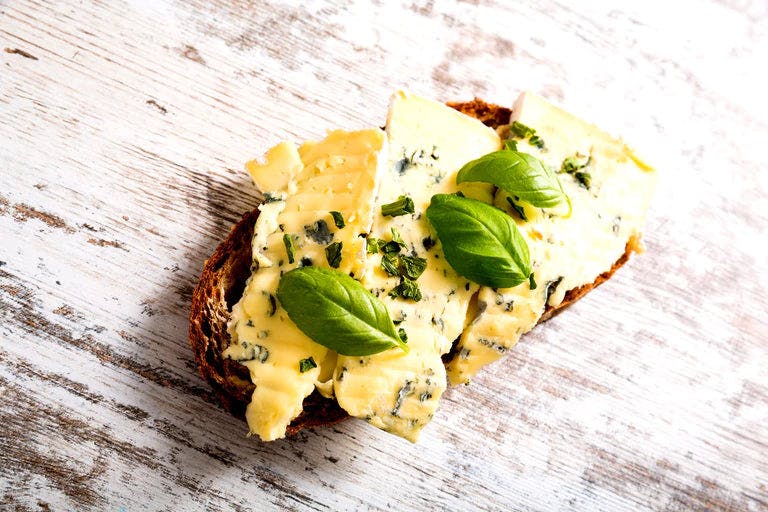 Slice of bread with butter and basil
