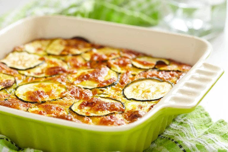 Baked vegetable gratin in green pan