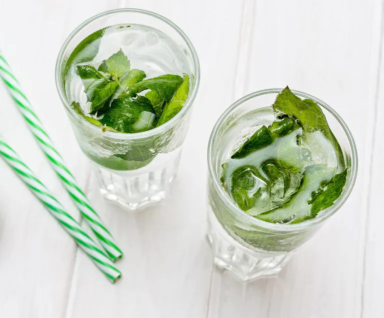 Two glasses filled with Lime Mojito