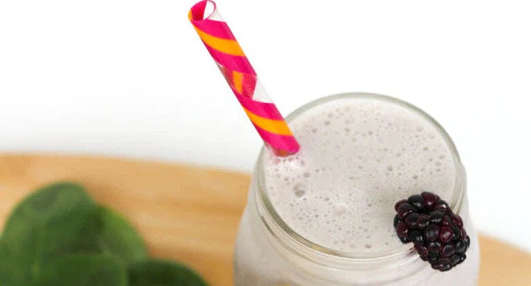 Good morning smoothie in a glass with a straw.