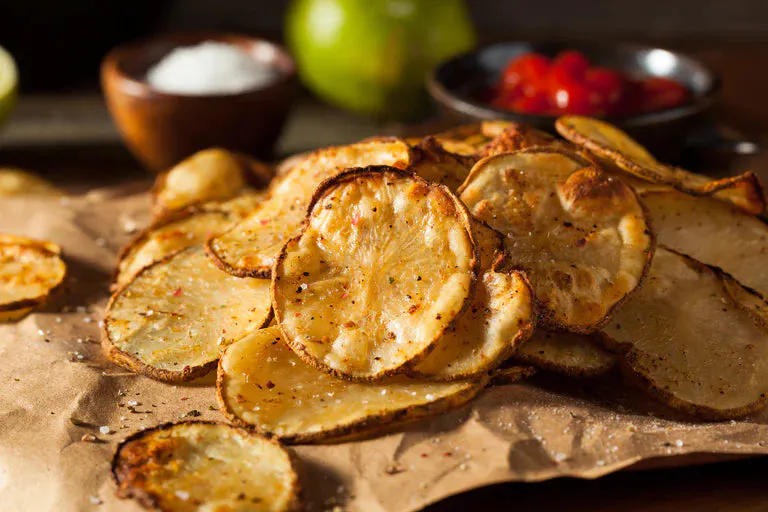 A bowl of crispy potato and sweet potato chips