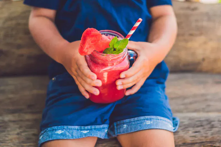 Refreshing true citrus slushies in a clear cup with a straw