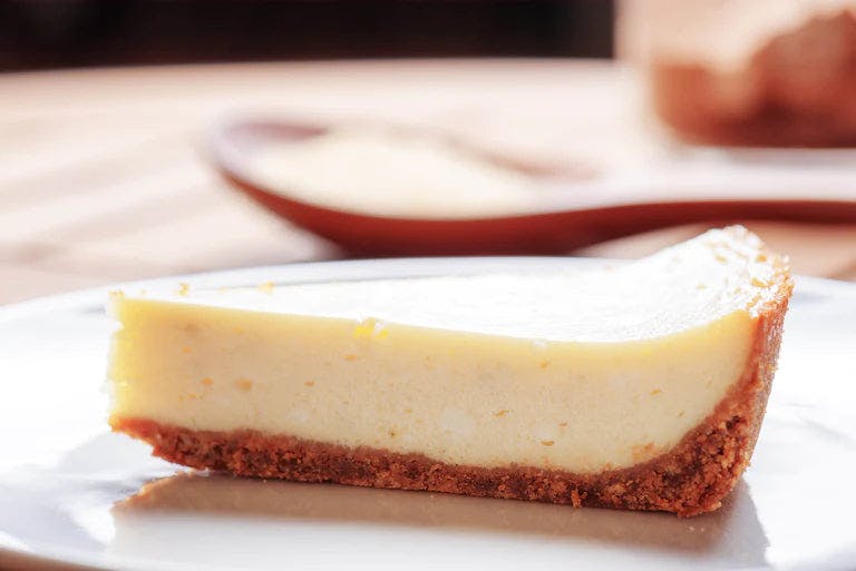 A slice of lemon cheesecake.