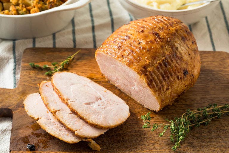 Lemon herb roasted turkey breast on a platter