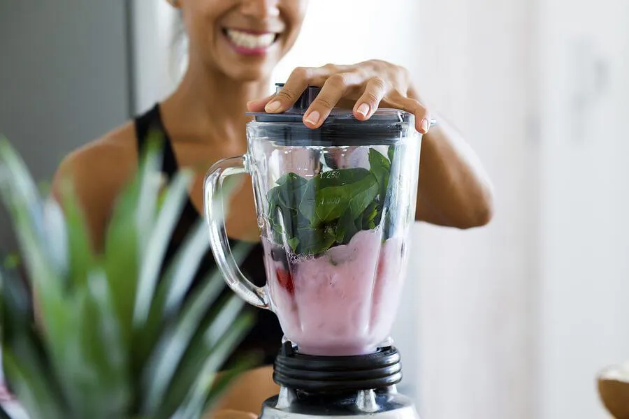 A woman making a smoothie.