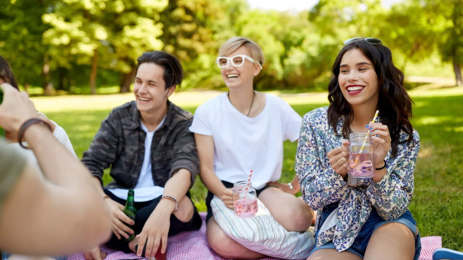 A group of friends enjoying meals made with True Lemon at an easy summer picnic.
