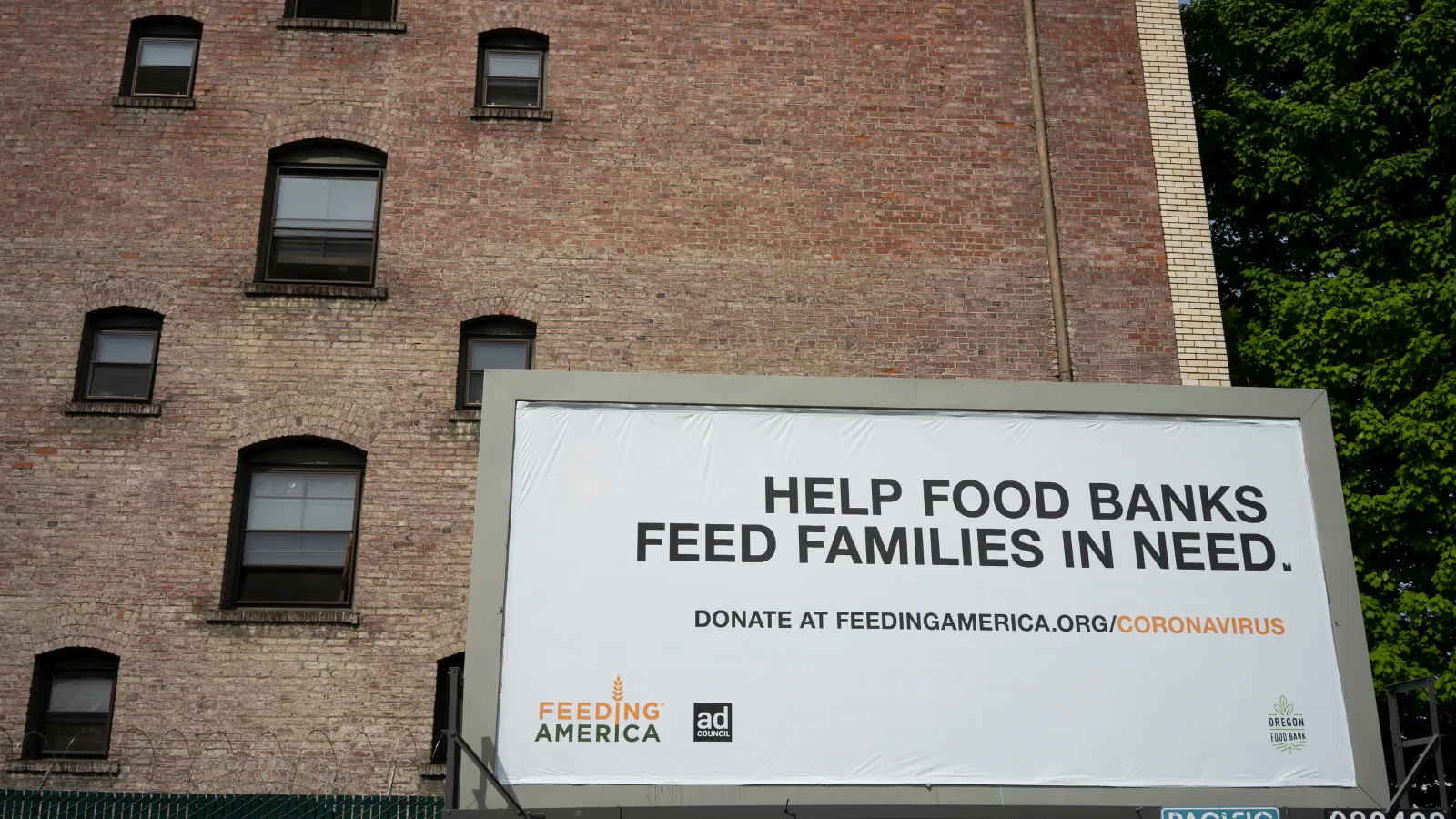 A Feeding America Billboard that reads "Help food banks feed families in need."