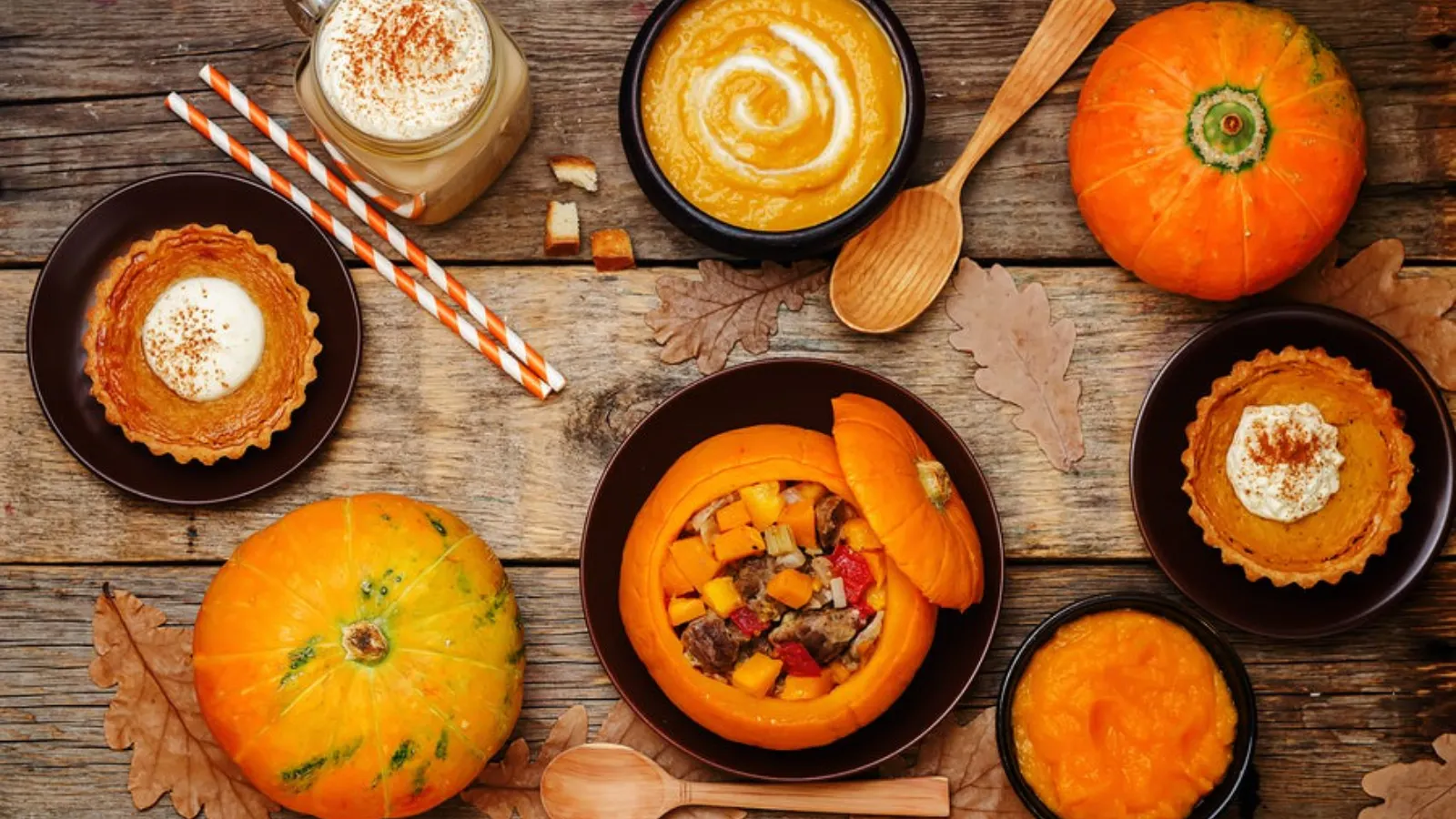 An assortment of pumpkins and pumpkin dishes on a table.