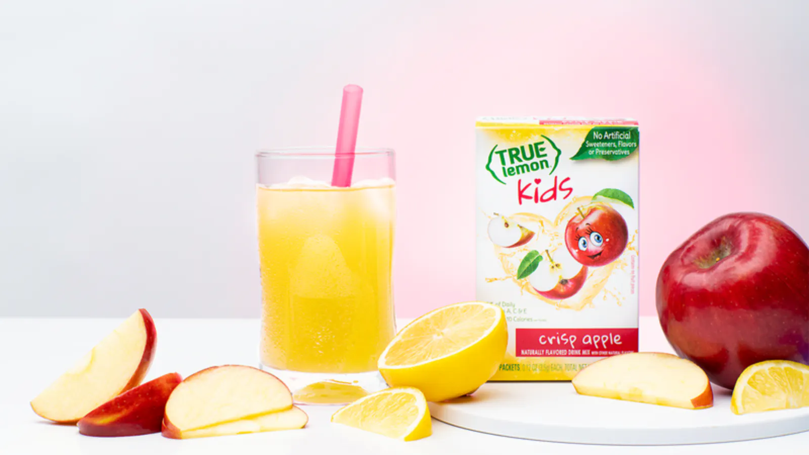 True Lemon Kids Crisp Apple on a table with a glass and freshly sliced apple.