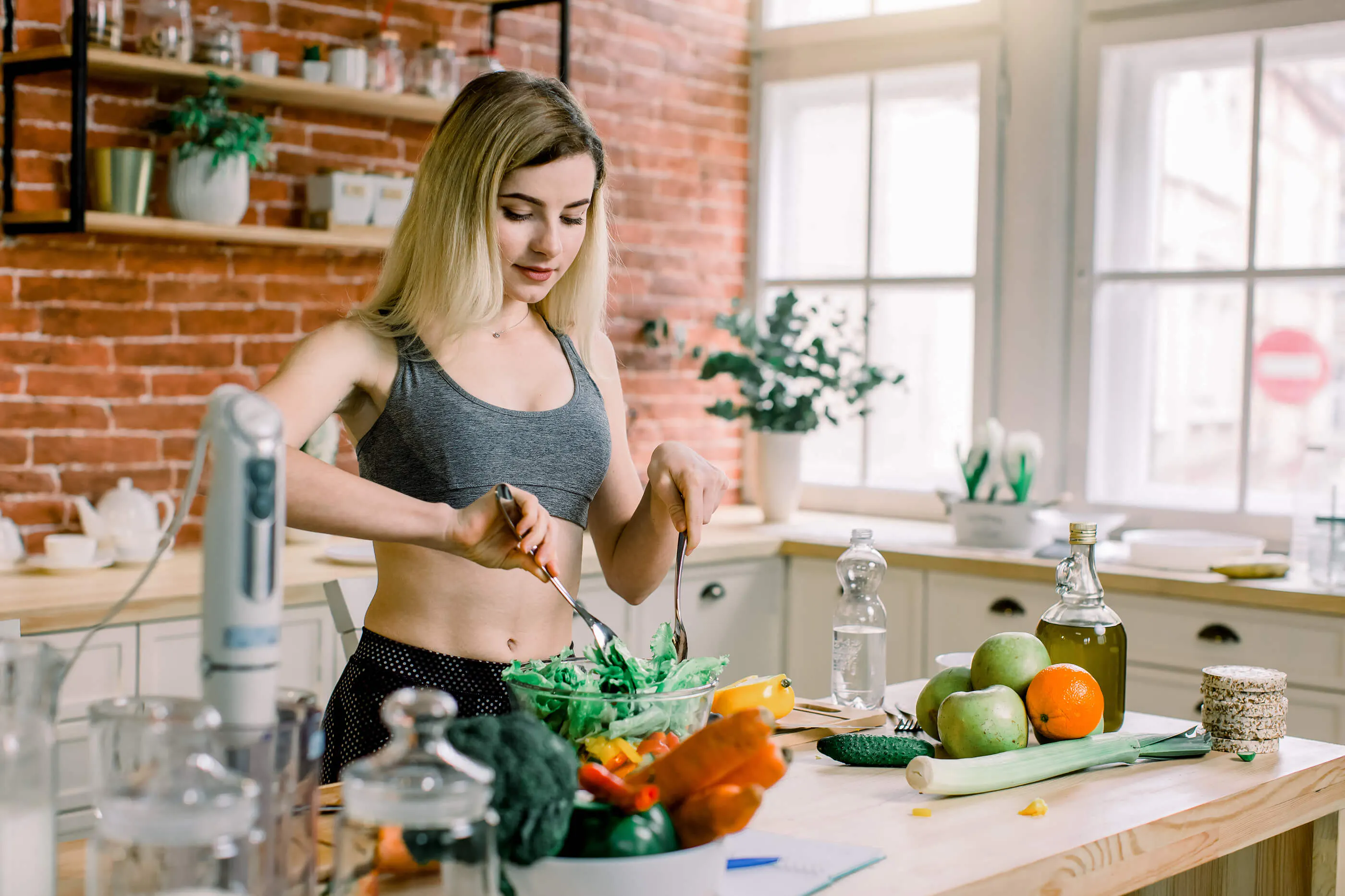 young-woman-preparing-healthy-food-cooking-vegetables-in-kitchen-at-home-healthy eating-spring-diet