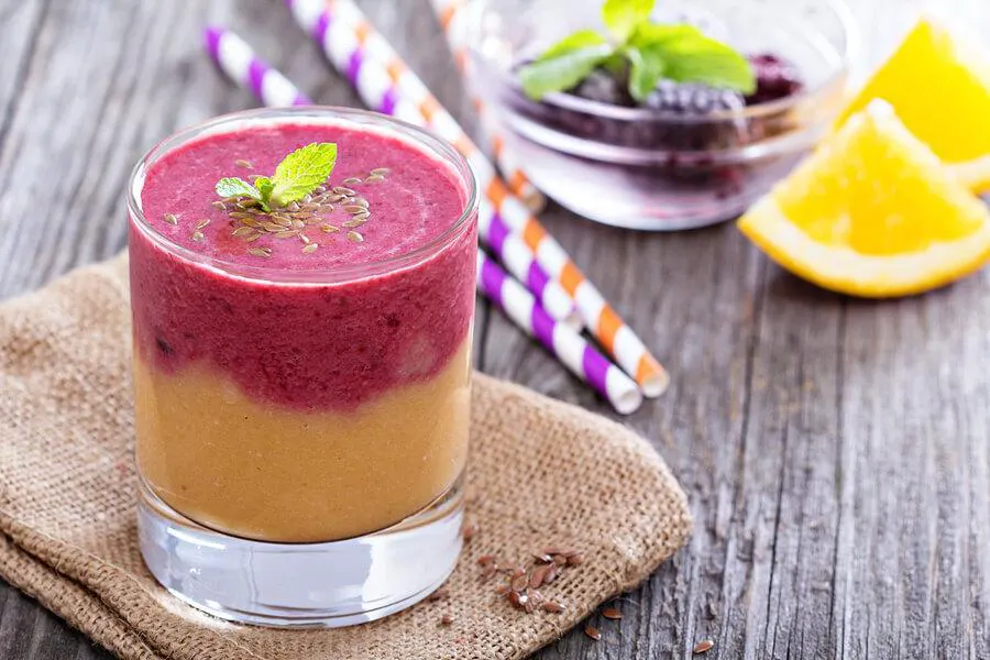 colorful smoothie with fresh fruit and herbs in a glass