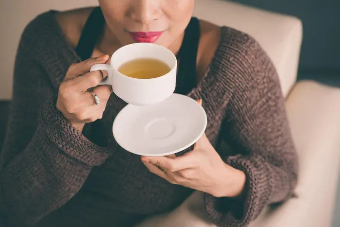 women sips tea
