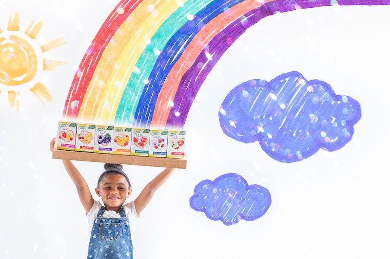 Little girl holding kids True Lemon Lemonade with rainbow and cloud graphics