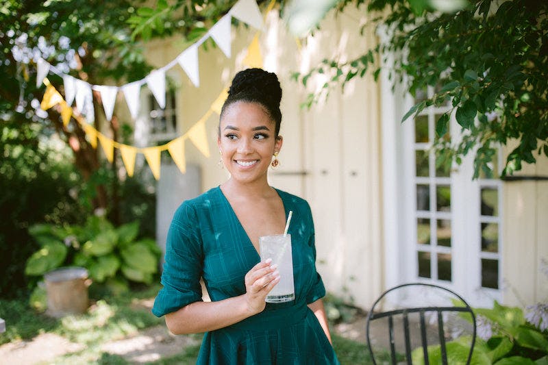 Smiling woman looking over the camera in green