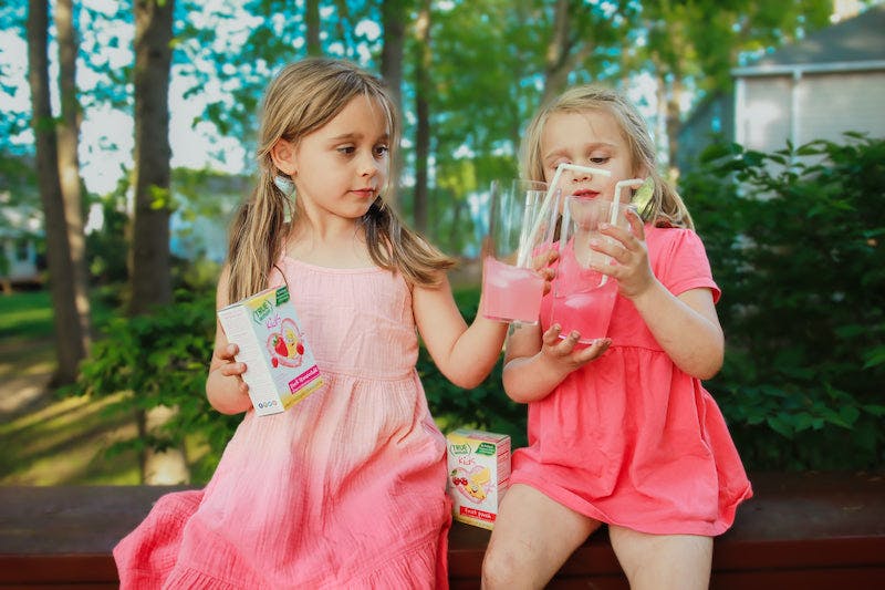 Two girls sipping lemonade